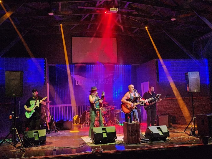 Band playing on the music stage under colored lights