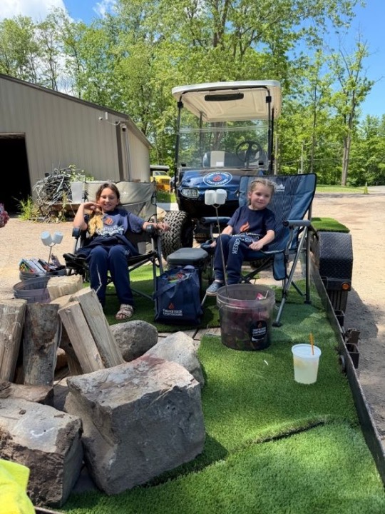 Campers relaxing around a fire pit